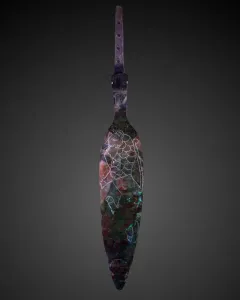 Spear of Lugal with a leaf-shaped metal blade, engraved animal motif, and perforated tang on a dark background.
