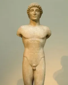 Apollo Strangford marble kouros statue with missing arms and lower legs, shown frontally on a dark base.