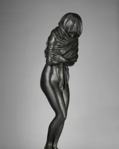 Winter, a dark bronze female figurine wrapped in heavy drapery and standing on a circular base.