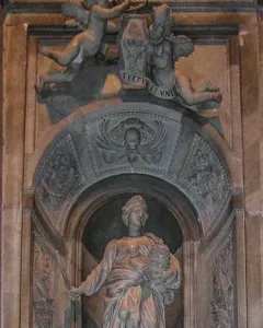 Marble tomb monument to Countess Matilda of Tuscany with a draped female figure in an arched niche, flanked by putti and a crest.