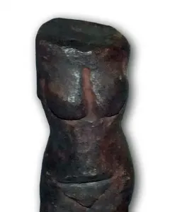 Replica of the Venus of Petrkovice showing a dark prehistoric female torso with pronounced breasts and hips.