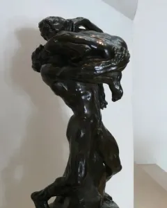 I Am Beautiful bronze sculpture of two intertwined nude figures with a French inscription on the base.