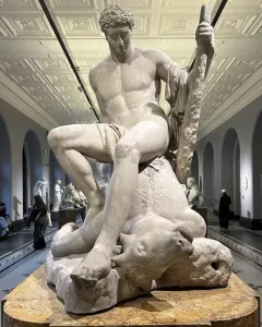 Theseus and the Minotaur marble sculpture by Antonio Canova, showing Theseus seated on the defeated Minotaur in a museum hall.