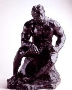 The Athlete, a dark metallic sculpture of a muscular seated man leaning forward on a rocky base.