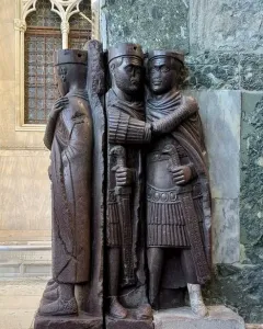 Portrait of the Four Tetrarchs, a dark reddish-purple porphyry sculpture of four stylized figures embracing in two pairs.