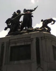 National Monument of Costa Rica with bronze figures in an action scene atop a stone pedestal