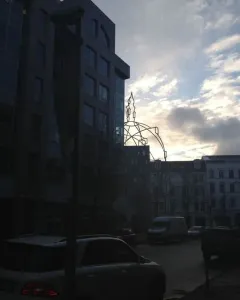 Memoria Urbana, a skeletal church outline silhouetted against a cloudy sky in Berlin.