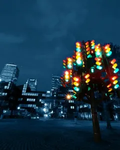 Traffic Light Tree sculpture glowing with red, green, and amber lights at night