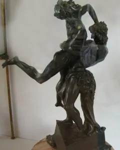 Hercules and Antaeus bronze sculpture showing two muscular figures in a struggle on a marble pedestal.