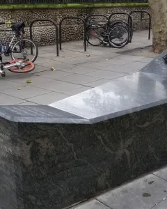 A Conversation with Oscar Wilde granite monument with a bronze bust holding a cigarette.