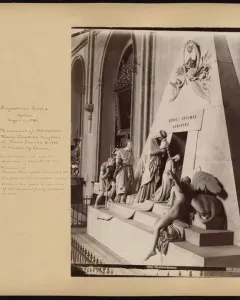 Cenotaph of Archduchess Maria Christina with a white pyramidal monument and sculpted mourners approaching a dark entrance.