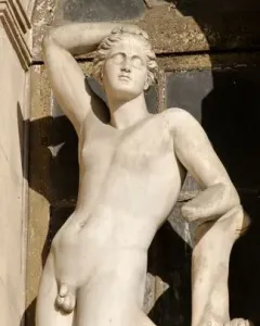 Apollino, a nude young male statue with one arm raised and a quiver beside him.