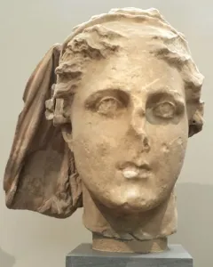 Lycosoura Demeter stone head with worn facial features and a draped veil-like covering