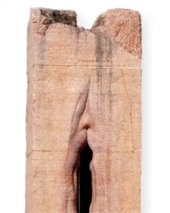 Pi-Chacán stone sculpture with a vertical vulva-like opening and subtle facial features at the top.