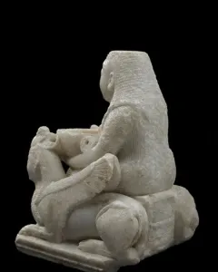 Lady of Galera seated stone figurine holding a bowl, flanked by winged creatures