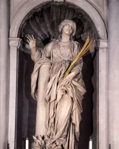 St Bibiana by Bernini, a marble statue of a woman in a shell-topped niche, gazing upward with one hand raised and holding golden fronds.