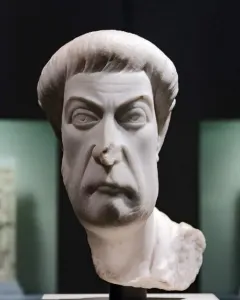 Marble bust of Eutropius with a stern expression, short cropped hair, and a textured beard and mustache.