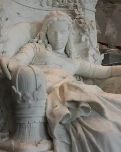 Sleeping Beauty marble sculpture of a resting woman in an ornate carved chair