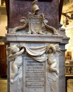 Tomb of Ferdinand van den Eynde with winged putti holding a draped banner above an inscribed marble plaque.