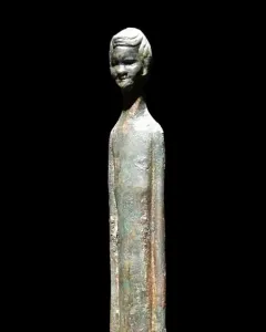 Ombra della Sera bronze figure with a long slender body and detailed head on a black background.