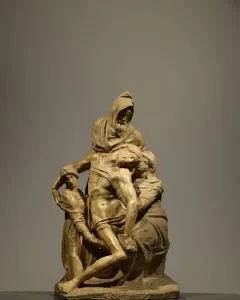 Michelangelo’s The Deposition marble sculpture showing the dead Christ supported by three robed figures.