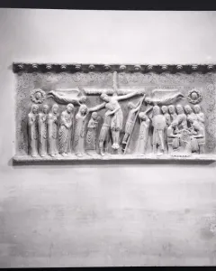 Marble relief of the Descent from the Cross with a crowded scene of figures surrounding the lowered body of Christ.