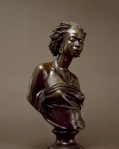 The Nubian Woman bronze bust of a woman with braided hair, hoop earrings, and a beaded necklace on a fluted pedestal.