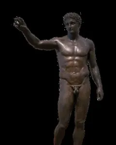 Antikythera Ephebe, a dark bronze nude male youth statue with short curly hair and one arm extended, on a light base against a black background.