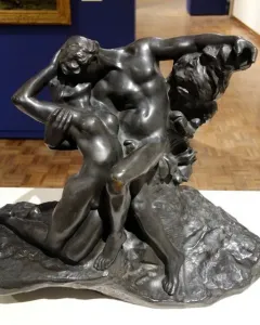 The Eternal Springtime bronze sculpture of a man and woman embracing on a rocky base.