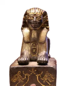 Thutmose III sphinx with a dark body and gold detailing on the headdress, beard, and collar