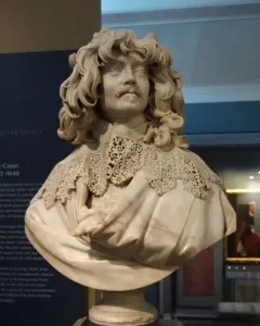 Bust of Thomas Baker with curly hair, a mustache, and an elaborate lace collar.