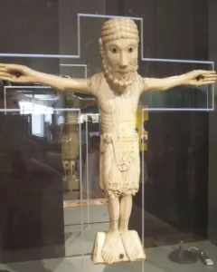 Carrizo Christ, a carved figure of Christ with outstretched arms, beard, braided hair, and a waist garment.
