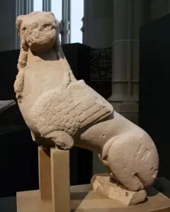 Sphinx of Agost stone sculpture with a human head, wings, and an animal body on a base.