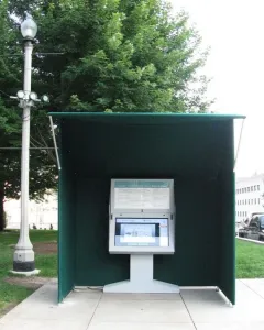 Burnham Pavilions canopy sheltering an interactive touchscreen kiosk on a concrete plaza.