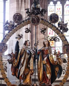 Angelic Salutation carved wooden sculpture with an angel and a woman inside an ornate circular frame