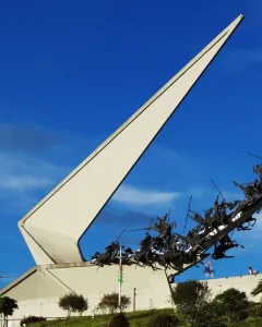 Vargas Swamp Lancers monument with white triangular structure and dark horsemen charging uphill