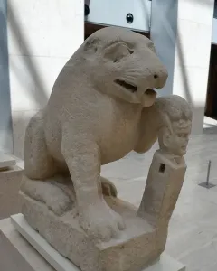 Bear of Porcuna stone sculpture showing a seated animal with one paw resting on a carved human-headed pillar.