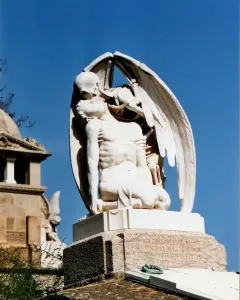 The Kiss of Death marble sculpture showing a winged skeleton kissing a kneeling man.