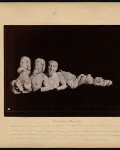 Trisomatos Typhon sculpture with three conjoined bearded male torsos and a coiled serpentine lower body.