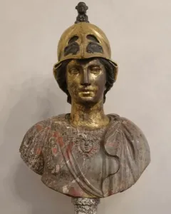 Bust of Athena Giustiniani with a gilded female head and helmet above a mottled marble torso with drapery and a Medusa head.