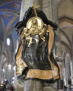 Memorial to Maria Raggi with a central medallion, two golden putti, and a cross on a church pillar