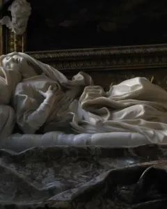 Ecstasy of Blessed Ludovica Albertoni by Bernini, a white marble figure reclining on a sculpted bed with her head tilted back and hands on her chest.