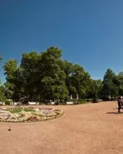 Catherine II Monument rising above a paved square under a clear blue sky, with a central figure and smaller seated figures on the pedestal.