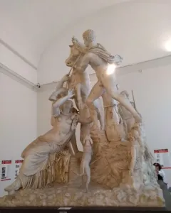 The Farnese Bull marble sculpture showing a dramatic scene with two men struggling to subdue a bull and a female figure beneath it.