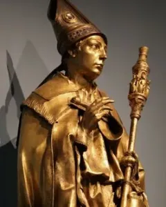 Saint Louis of Toulouse shown as a gilded standing statue holding a staff and a small book.