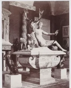 The Fountain of Diana, a marble sculpture of a nude woman with a bow embracing a stag, with two dogs on the basin below.