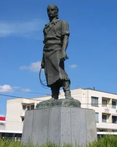 Laçador statue of a gaucho standing on a stone pedestal with a lasso in hand.