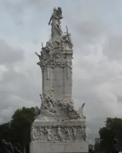 The Monument to the Carta Magna and the Four Regions of Argentina, a tall white stone sculpture with a standing female figure on top and detailed reliefs below.