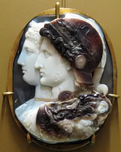 Gonzaga Cameo showing two carved profile portraits in a gold frame, with a helmeted figure in front and another profile behind.