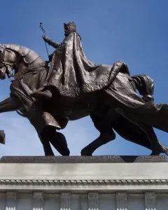 Apotheosis of St. Louis, a bronze equestrian statue of a crowned figure on a rearing horse against a blue sky